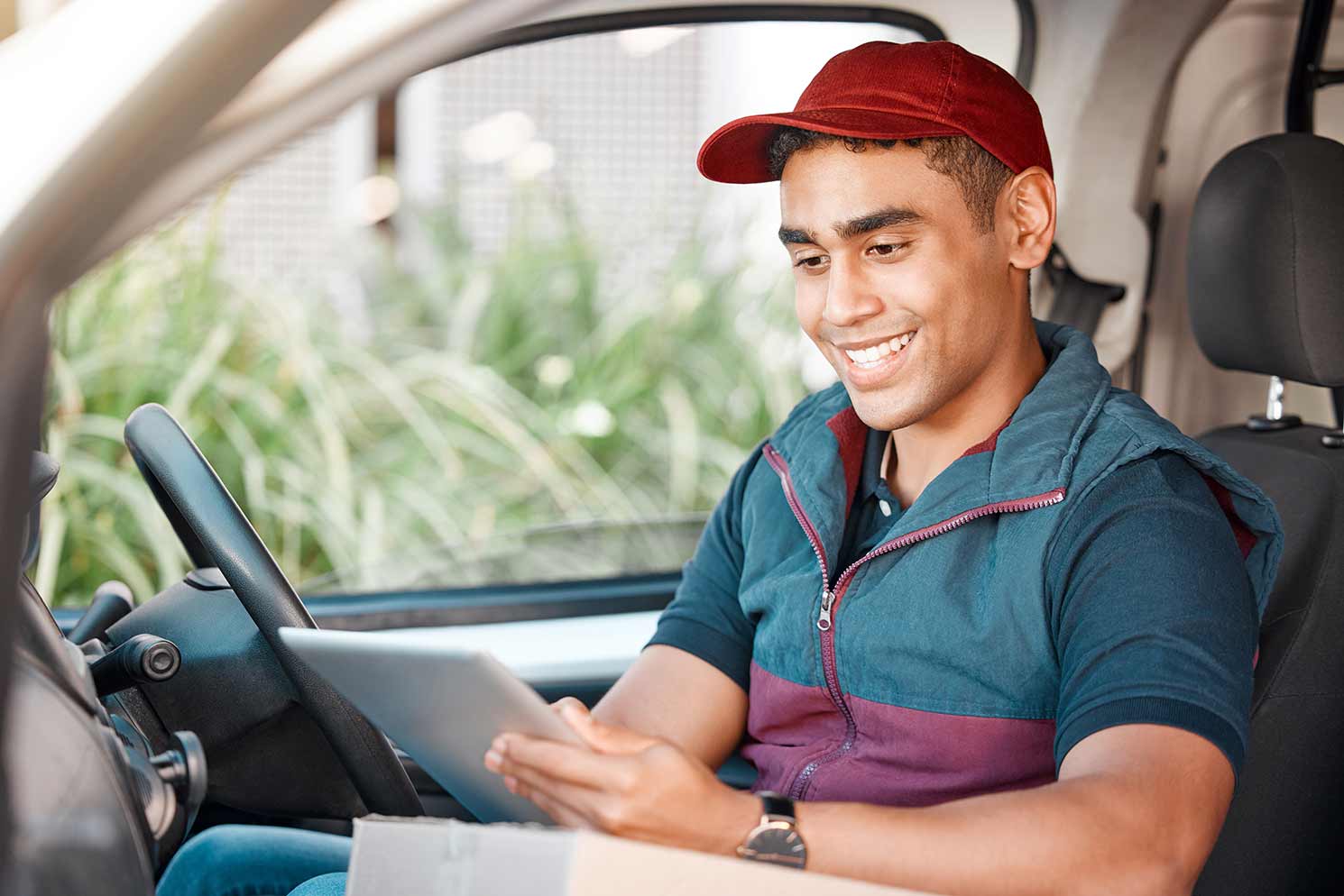 Courier checking his mobile courier software app to see where his next delivery is.